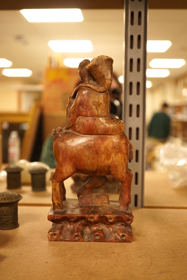 Chinese items comprising a soapstone carving, three jade carvings, one with gilt metal pendant mounts and two brass knops